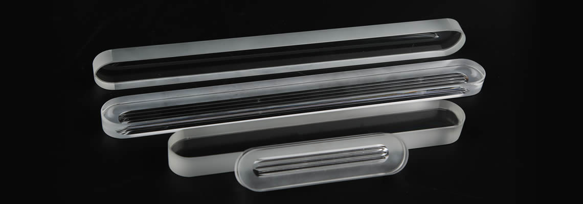 Four rectangular bar shape gauge glass in different length on the black background.