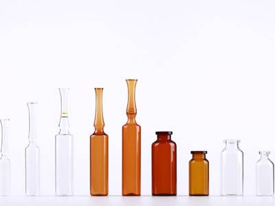 Several vials made of borosilicate glass on the white background.