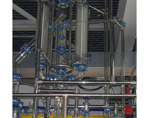 There is a production equipment with glass coil pipe condenser in biological factory.