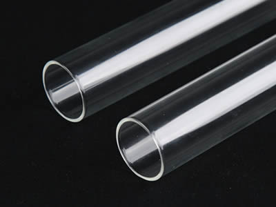 Two glass test tubes with flat top on the black background.