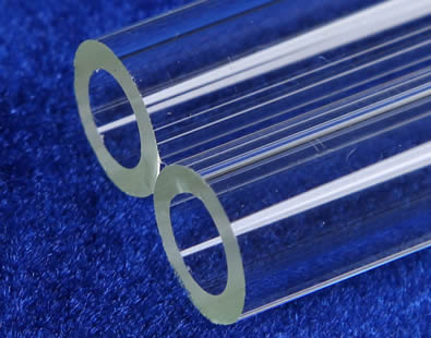 Two heavy wall capillary tubes with clear surface and polished edge lie on the table.