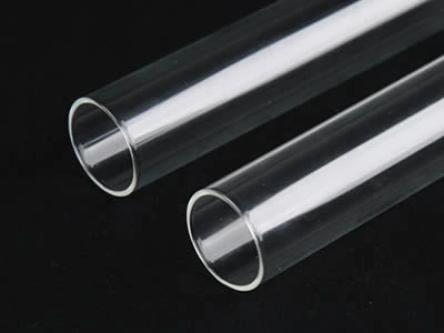 Two laboratory culture tubes with flat top on the black background.