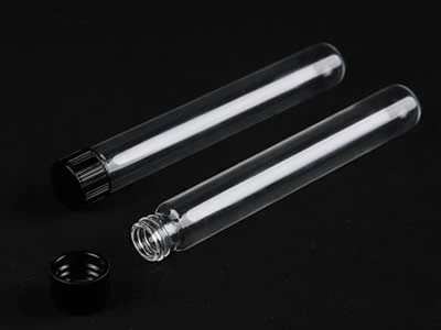 A closed and an opened laboratory culture tube with black color plastic screw stopper on the black background.