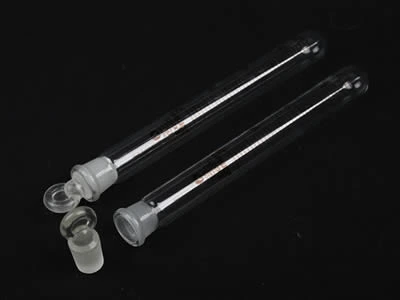 A closed and an opened laboratory culture tube with quartz stopper on the black background.