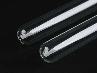 Two laboratory culture tubes with round bottom on the black background.