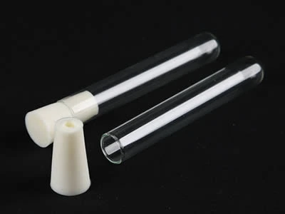 A closed and an opened laboratory culture tube with silicone stopper on the black background.