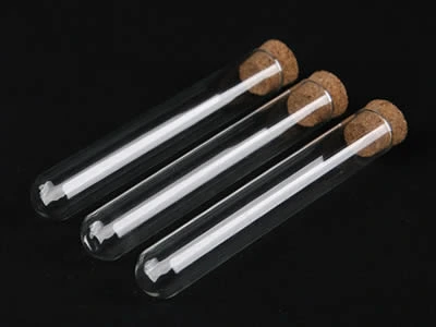 Three laboratory glass culture tubes with cork stoppers and round bottom on the black background.