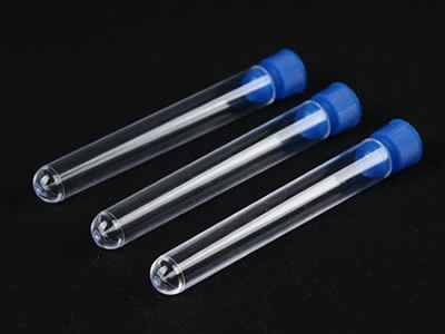 Three laboratory plastic culture tubes with blue color plastic stoppers on the black background.