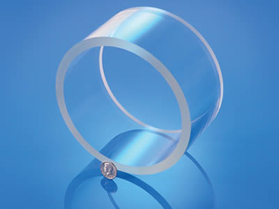 A short straight polished precision glass tube with a coin diameter thickness wall.